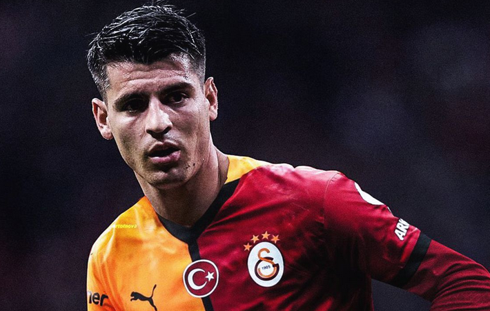 A male soccer player in a red and yellow Galatasaray jersey looks to the side during a match, reminiscent of Spain Captain Fabregas’s intense focus on the field.