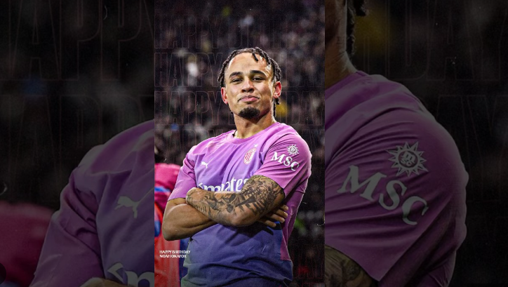 A football player in a pink jersey stands with arms crossed, looking confidently at the camera—reminiscent of Okafor’s bold presence on the Milan pitch.