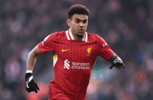 A soccer player in a red Liverpool jersey, possibly Diaz, sprints across the field during a match.