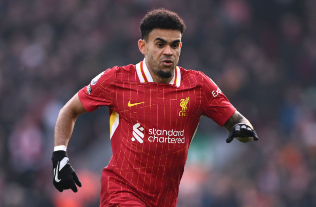 A soccer player in a red Liverpool jersey, possibly Diaz, sprints across the field during a match.