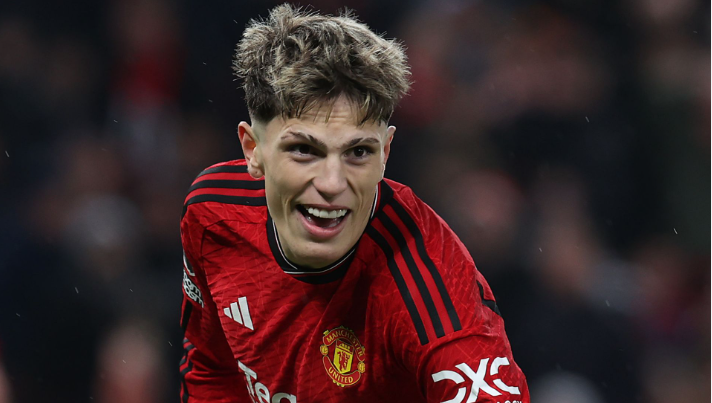 Man Utd's Garnacho, wearing a red Manchester United jersey, smiles during a thrilling Premier League match.